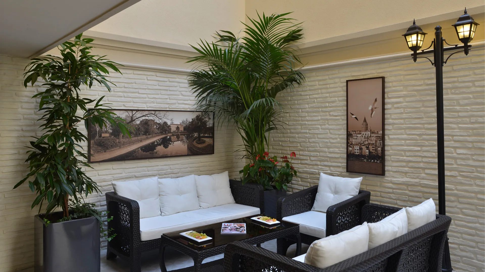 Garden Cafe: brick wall, palms and a lantern